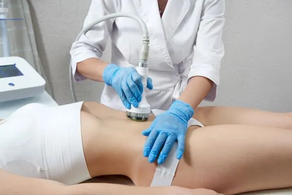 Lost the Weight but Not the Loose Skin? 2 woman having HIFU treatment on her stomach to combat loose skin Bricket Wood following weight loss